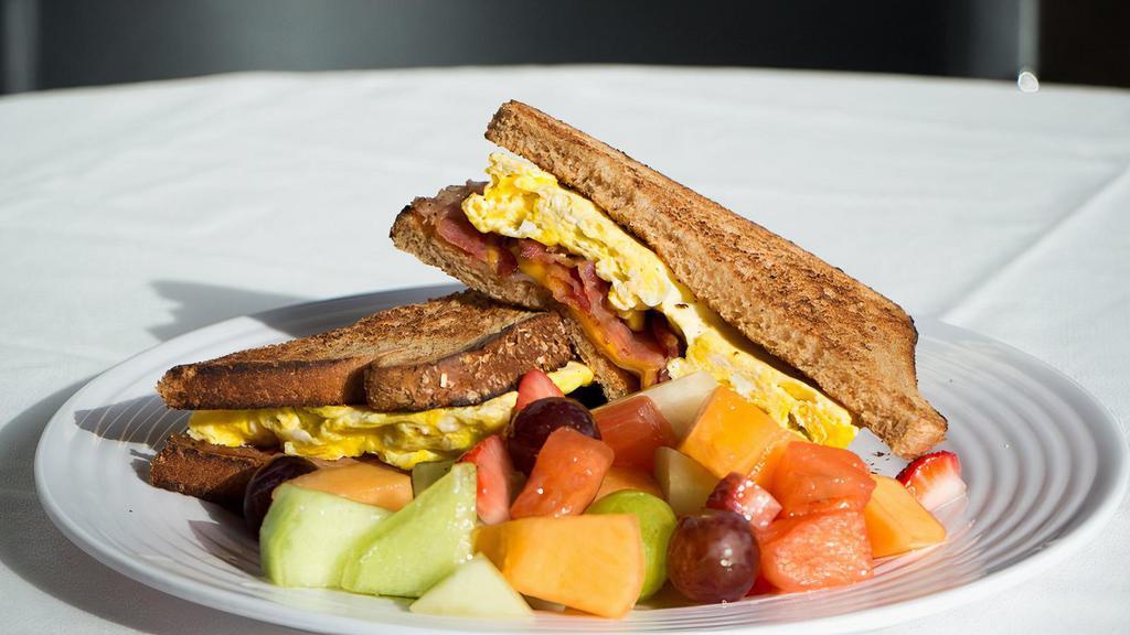 Toast Breakfast Sandwich · Choice of toast with two eggs, cheese and choice of meat.Choice of bacon, ham or sausage