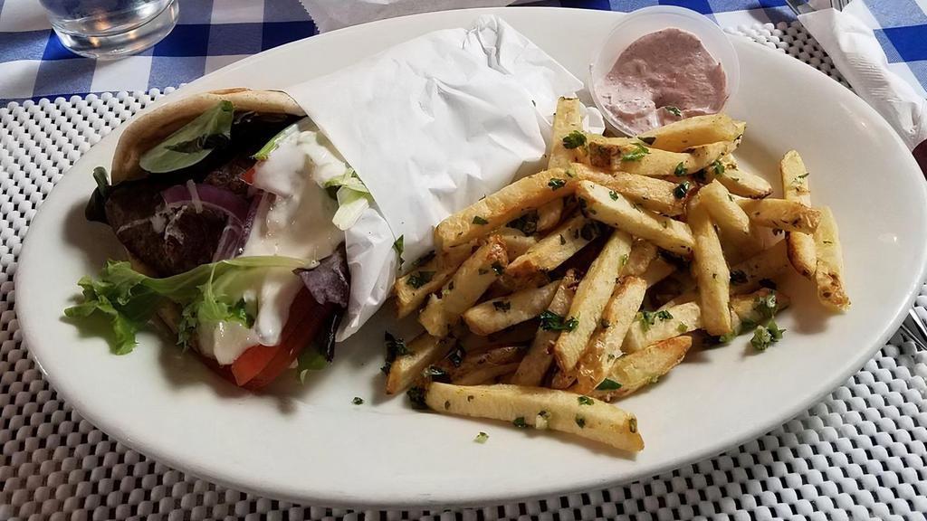 Gyro Pita Wrap · thin sliced beef wrapped in warm pita, topped with spring greens, tomato, onion, tzatziki, and fries