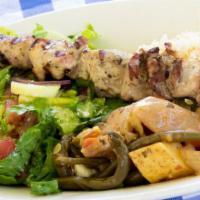Chicken Souvlaki Plate · Tender pieces of marinated halal chicken thigh grilled on a skewer, served with rice and veg...