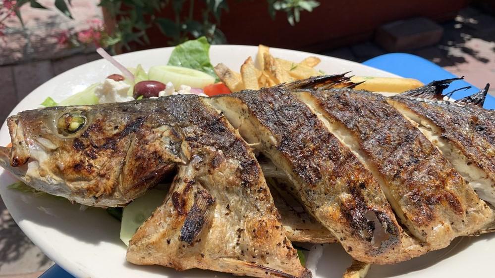 Grilled Branzini · This delicious special is back! Whole branzini is marinated in garlic, lemon, and olive oil.. then topped with oregano before its gently grilled to perfection. Served with fries and athena salad