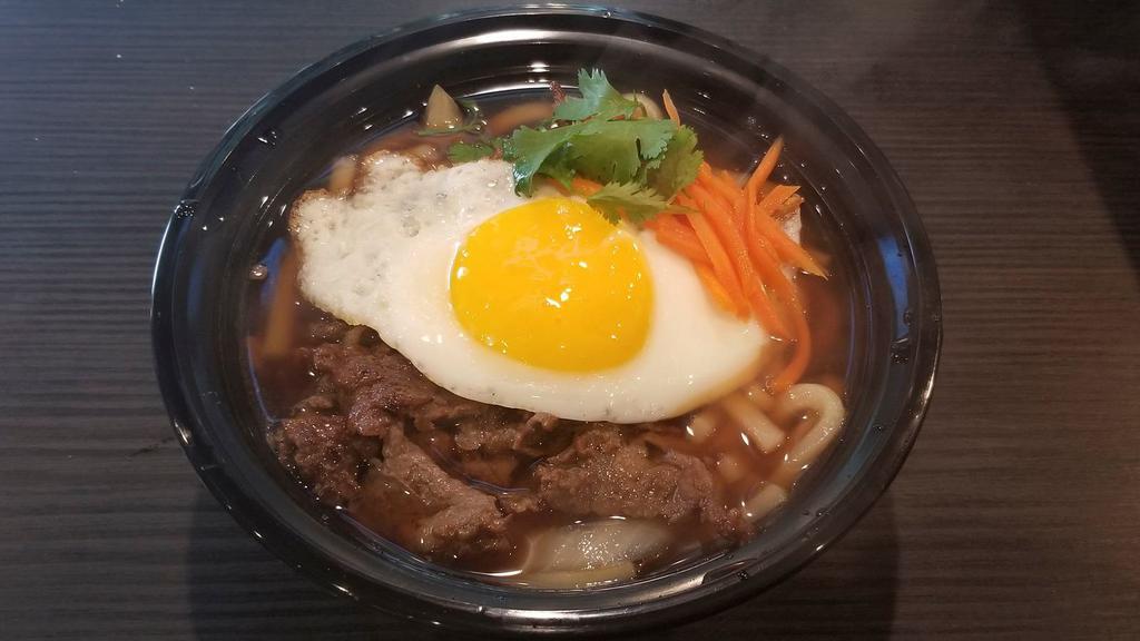 Bulgogi Udon · udon noodle soup with bulgogi, carrot, cilantro, and fried egg