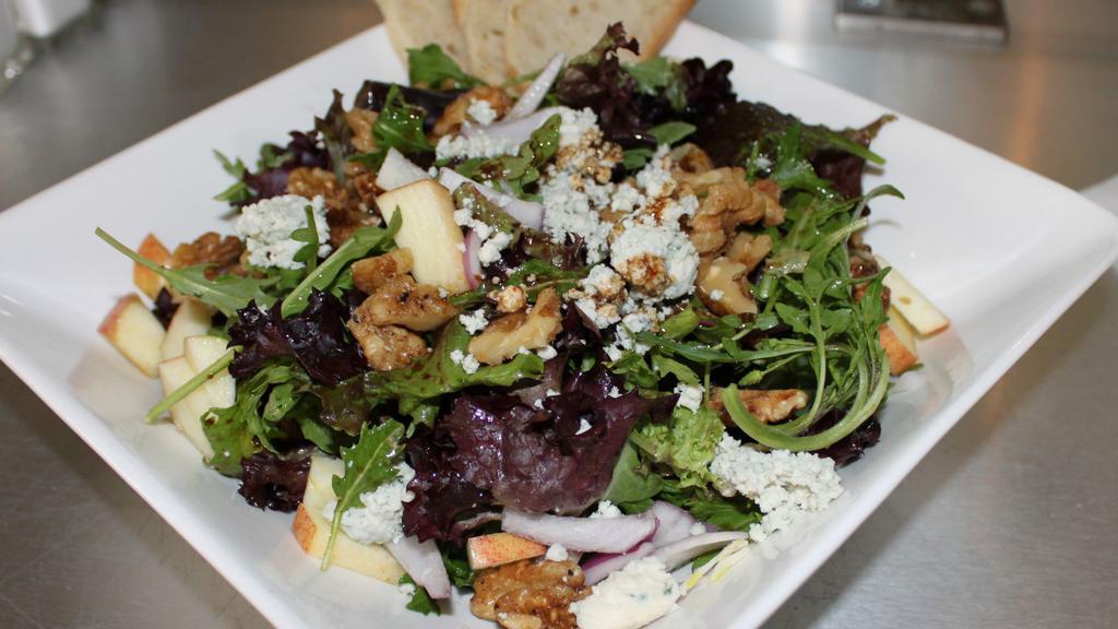 Blue Cheese & Walnut Salad · Fuji apple, red onion, maple walnuts, and crumbled blue cheese on bed of greens, drizzled with fig walnut vinaigrette.