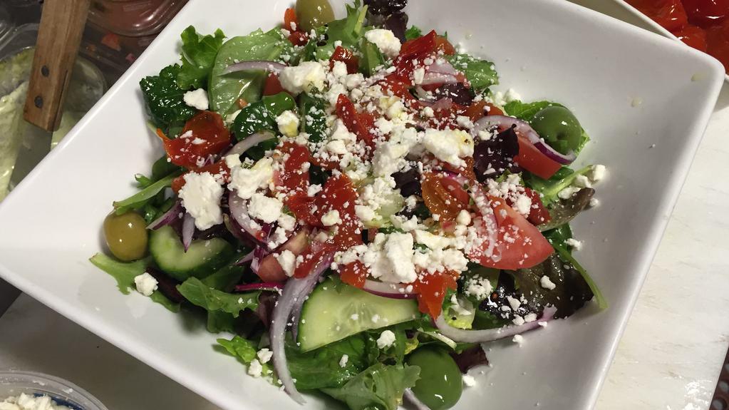 Greek Salad · Feta, tomato, cucumber, olives, chick peas, red onion on bed of romaine.