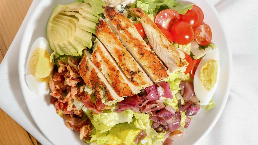 Cobb Salad · Grilled chicken, bacon, hardboiled egg, blue cheese, avocado, tomatoes, grilled onions, tarragon ranch.