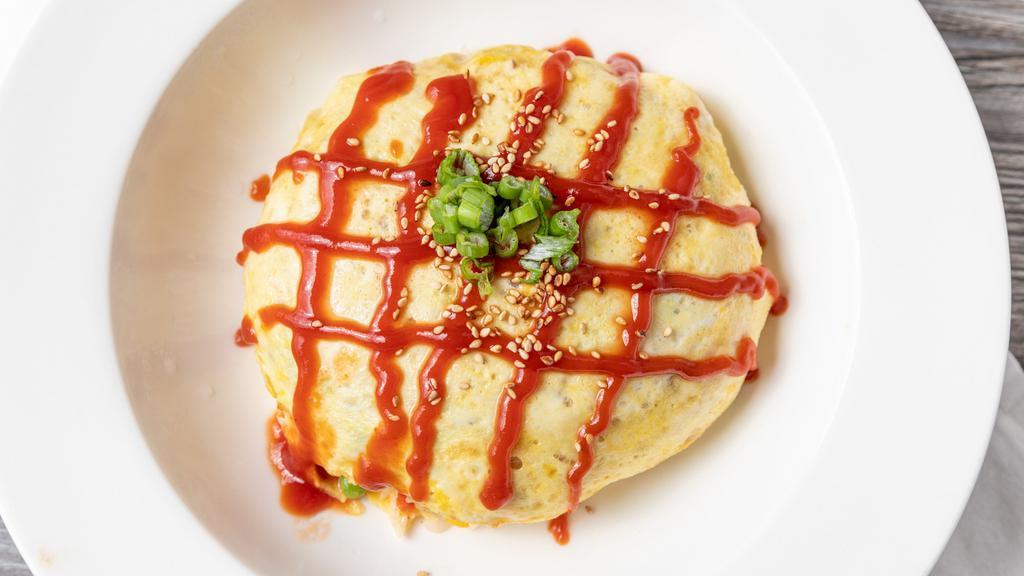 24. Omelette Rice · Fried rice with shrimp and vegetables wrapped in an egg omelette.