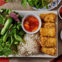 A2. Cha Gio (3 Rolls) · Vietnamese fried eggrolls with lettuce and mint leaves serve on plate.