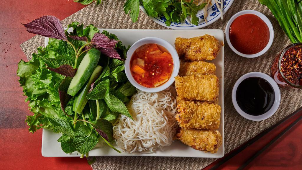 A2. Cha Gio (3 Rolls) · Vietnamese fried eggrolls with lettuce and mint leaves serve on plate.