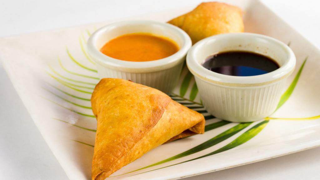 Potli Samosa (2 Pcs) · Vegetarian turnovers stuffed with potatoes, peas, spices, herbs, and served with mint and tamarind chutney.