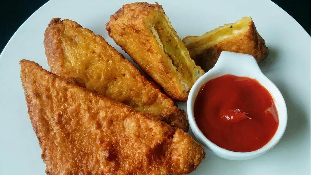 Bread Pakora- 4 pcs  ( New !) · Popular house hold snack !. Mashed  potatoes  and vegetables sandwiched between bread slices ,battered with  chick peas flour and deep fried . Served with Tamarind chutney.