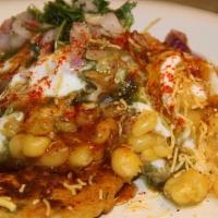 Aloo Tikki Chaat · Shallow fried potato pastries stuffed with cheese and green peas. Served with curried chick ...