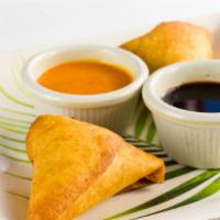 Lamb Samosa(2 Pcs) · Widely popular triangle pastries stuffed with ground lamb and spices.Served with home made c...