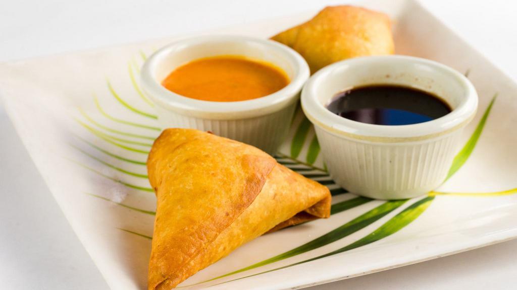 Crab Samosa(2Pcs) · Feast on fresh California crab !!
Triangle pastries stuffed with fresh crab meat sauteed with peas and corn and deep fried .Served with home made chutneys.