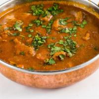 Goat Curry · Fresh goat meat cooked to perfection with ginger and garlic paste, tomatoes, onions, and gar...