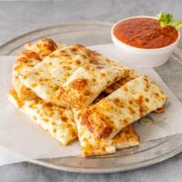 Cheesy Bread · medium sized bread, with olive oil, topped with cheese and seasoning