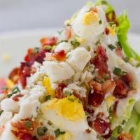 Wedge Salad · crisp wedge salad top with bacon crumbles, walnut pesto,tomatoes,iceberg,egg,red onion with ...