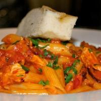 Penne Alla Pollo · Chicken strips sauteed in white wine with diced tomatoes, bell peppers, onions and herbs in ...