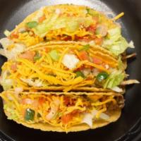 Chicken Taco · Crunchy taco shell, shredded rotisserie chicken, shredded iceberg lettuce, shredded mild che...