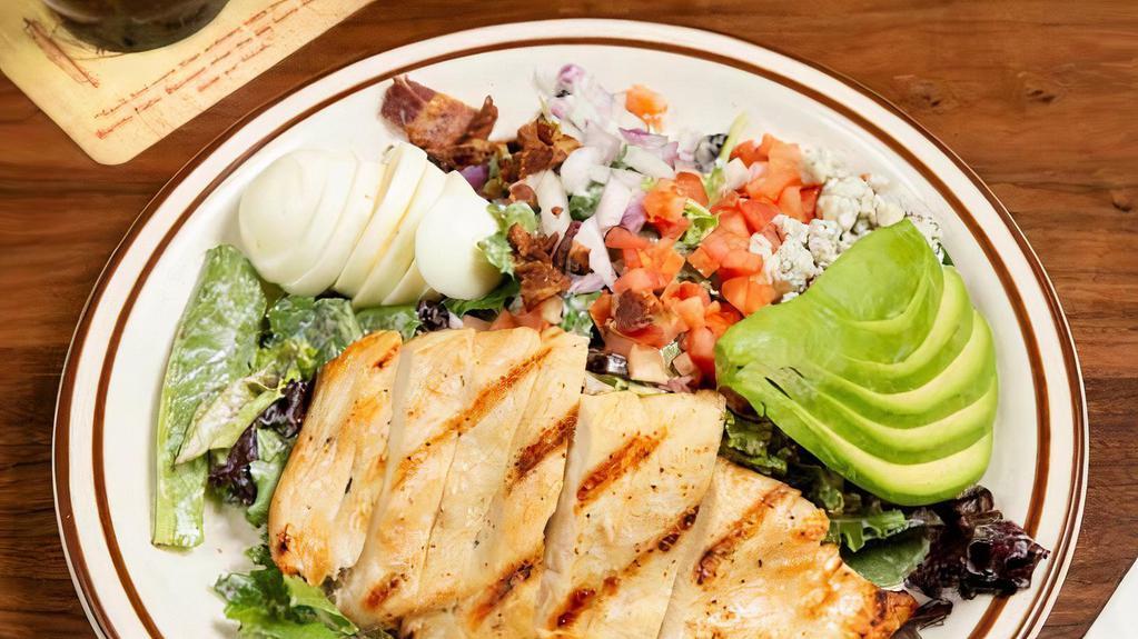 Cobb Salad · Spring mix, hard boiled egg, diced red onions, blue cheese crumbles, chopped bacon, cherry tomato, avocado, and grilled chicken.
