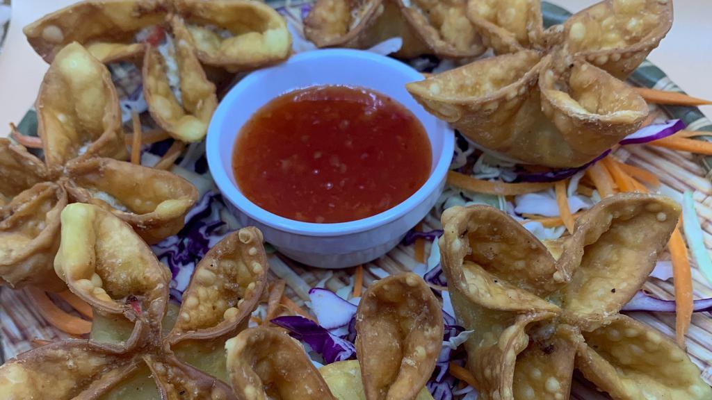 Crab Rangoon เกี้ยวปูทอด · Crab meat filled with cream cheese wrapped in wonton served with our secret sweet and sour sauce.