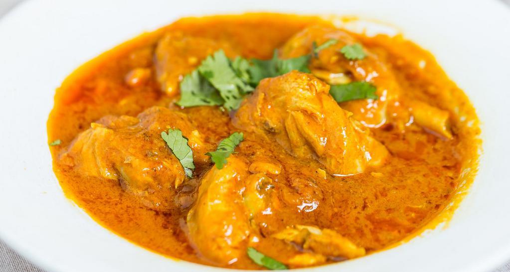 Chicken Curry · Medium. Chicken cooked in a blend of curry spices w/ tomato & onion.