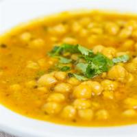 Chana Masala · Vegan, mild. Garbanzo beans cooked in Lahore style with onion sauce and aromatic seasoning.