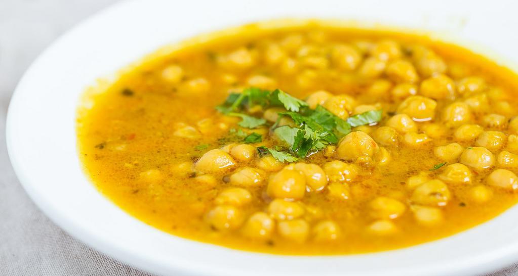 Chana Masala · Vegan, mild. Garbanzo beans cooked in Lahore style with onion sauce and aromatic seasoning.