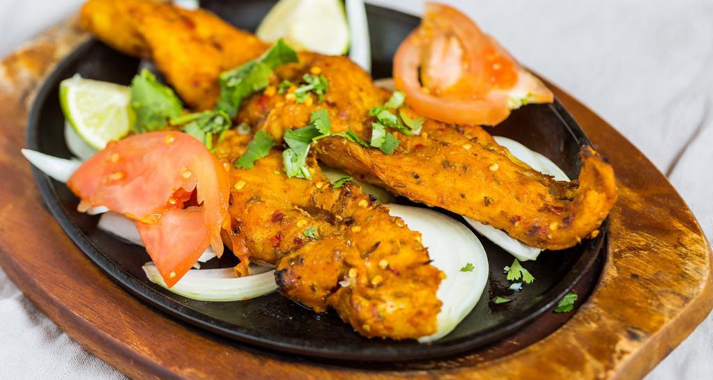 Fish Tandoori (2 Pcs) · Medium spicy. Marinated fish with garlic, herbs, and spices cooked in clay oven.
