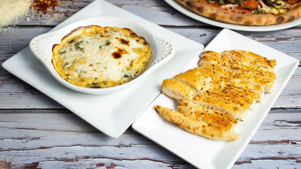 Aprilia's Artichoke and Spinach Dip · Oven baked dip made with artichokes, mozzarella cheese, garlic and Parmigiano Reggiano served with pieces of bread.