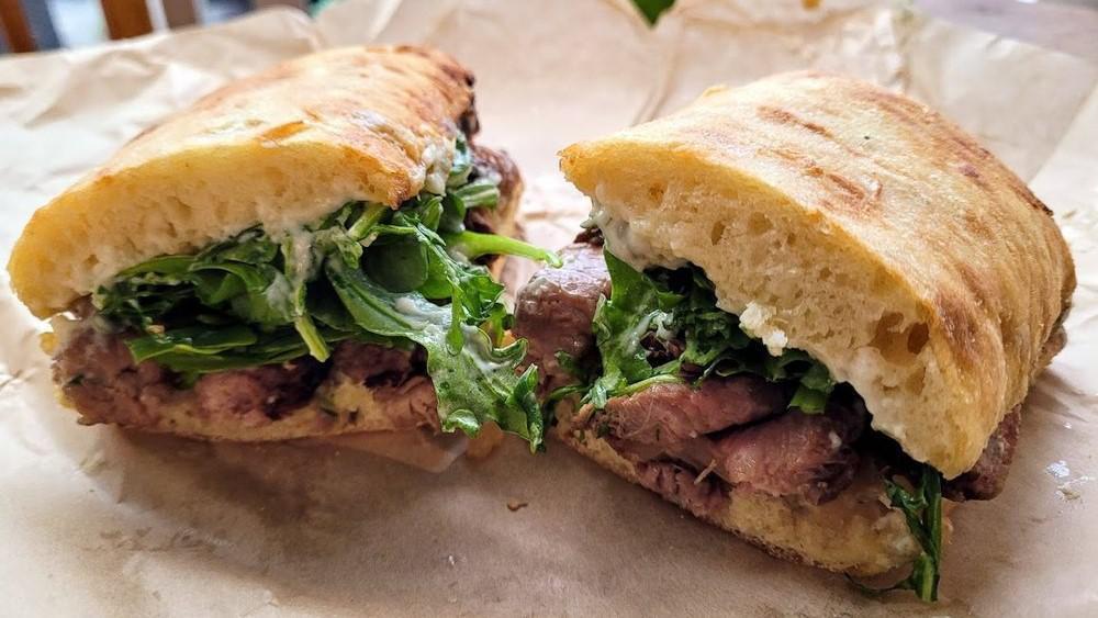 Steak and Blue
Sandwich (Whole) · Dairy, Served Gluten-free. Grass-fed steak, blue cheese, roasted garlic sauce, greens, grass-fed steak with caramelized onions.