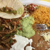 Fajitas · Chicken or beef with grilled veggies rice, beans, lettuce, tomato, sour cream & guacamole.