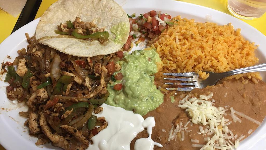 Fajitas · Chicken or beef with grilled veggies rice, beans, lettuce, tomato, sour cream & guacamole.