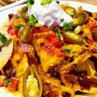 CHILI NACHOS.. · Homemade all-natural angus beef chili, cheddar cheese, pickled jalapenos, sour cream, green ...