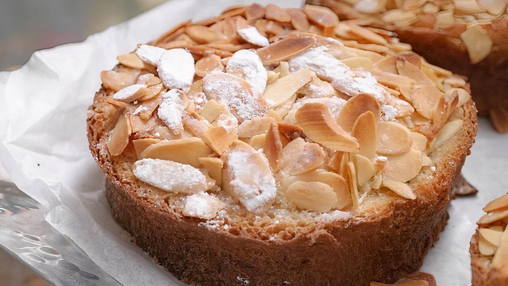 Apple and Almond · A buttery short dough tart shell filled with frangipane and sliced apples baked till tender, finished with an apricot glaze, garnished with sliced almonds that are then dusted with confectioners' sugar.