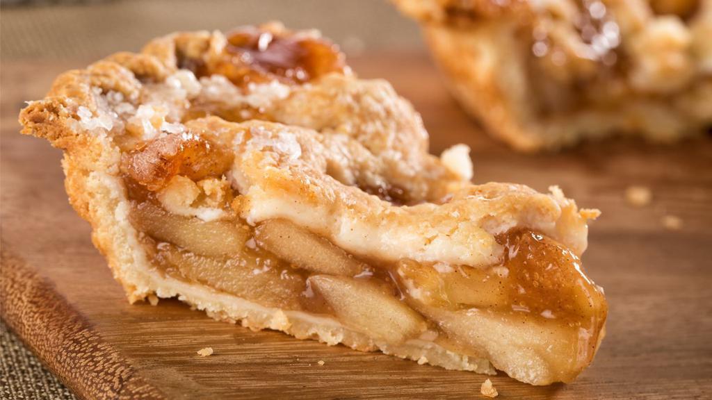Dutch Apple · A buttery short dough tart shell filled with sautéed apples, raisins, sliced almonds, topped with a butter streusel, baked to a golden brown and finished with a dusting of confectioners' sugar.