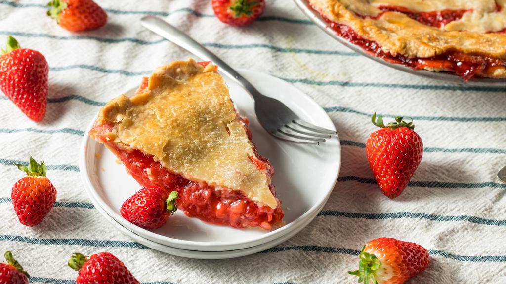 Strawberry Rhubarb · A buttery short dough tart shell filled with frangipane, strawberry and rhubarb slices, baked until golden, finished with an apricot glaze and garnished with fresh strawberry pieces, almond slices and confectioners' sugar.