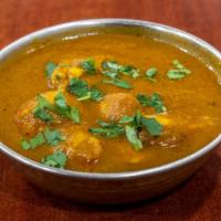 Chicken Curry · Indian-style curry made with boneless chicken marinated in chef's sauce in mild spices.