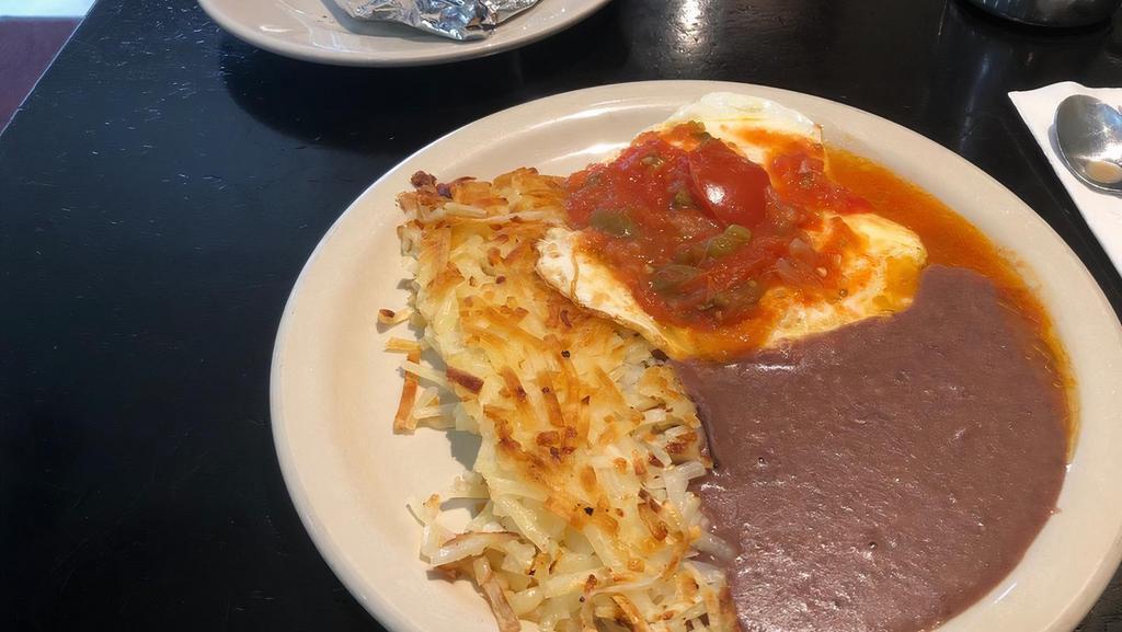 Eggs Rancheros · Two eggs topped with our homemade ranchero sauce, and refried beans.