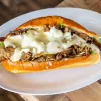 Raider Cheesesteak · Grilled steak or chicken, grilled onions and shrooms, arugula, white cheese sauce, and truff...