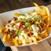 Bacon Fries · House made Cheddar cheese sauce, smoked bacon, green onions.