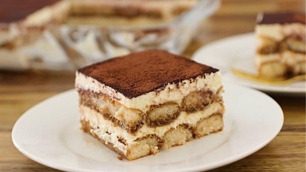Mama Rosa's Homemade Tiramisu · Rum and espresso-soaked sponge cake, layered with sweet mascarpone and chocolate cream, finished with cocoa
