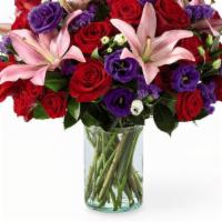 Carl Dean Bouquet · Carl Dean Bouquet is filled with pink lilies, red carnations, and purple accented flora.