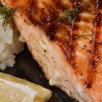 Salmon Filet. · topped with a citrus beurre blanc with a choice of 2 sides