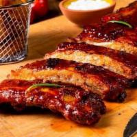 St. Luis Ribs. · slow cooked and glazed with BBQ sauce with a choice of 2 sides