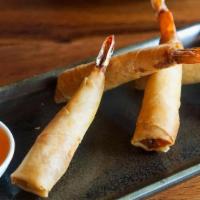Prawn Rolls · Deep fried marinated prawn wrapped in egg roll skin served with sweet & spicy sauce.