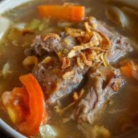 Oxtail Soup · Oxtail slow stewed with carrot, tomato, and cabbage. This dish is rich and hearty, with a gr...