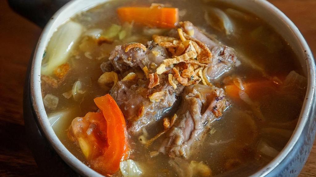 Oxtail Soup · Oxtail slow stewed with carrot, tomato, and cabbage. This dish is rich and hearty, with a great balance between sweet and salty.