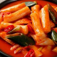 Soupy Dukbokki · Shimmered spicy rice cakes and fish cakes in a spicy sauce.