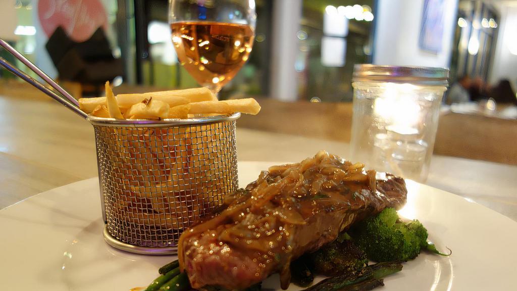 Steak Frites · Grilled 12 oz. grass-fed New York steak, sauteed seasonal vegetables, caramelized onions, Shoestring Fries