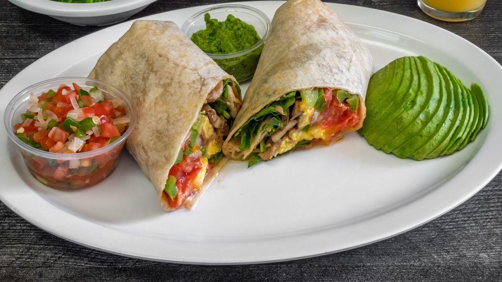 Avolicious Breakfast Burrito · Avocado, eggs, cheddar cheese, tomatoes and onions wrapped in a flour tortilla.