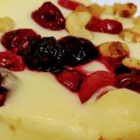 Cranberry Walnut Cheesecake · Cream cheese cake topped with Cranberries and Walnuts.